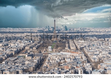 Paris, aerial view of the Eiffel Tower in a storm, with the Defense towers in background
