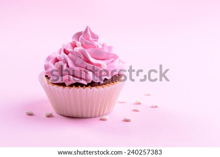 Delicious cupcake on pink background