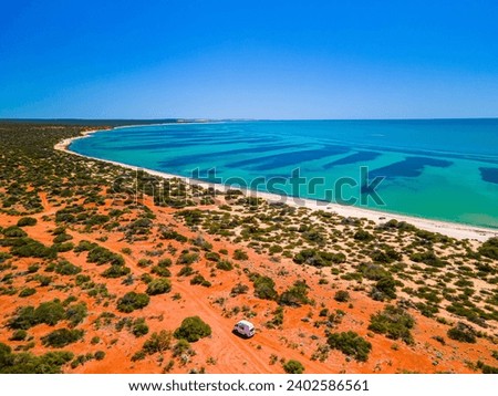 An aerial view of the picturesque coastline and sparkling blue ocean: Monkey Mia, Australia Royalty-Free Stock Photo #2402586561