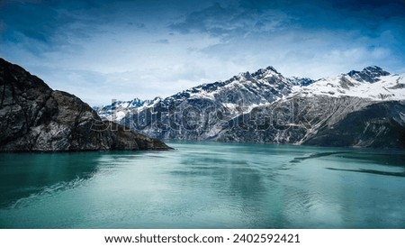 This scenic landscape shows a majestic mountain range in Glacier Bay National Park. Alaska, USA. Royalty-Free Stock Photo #2402592421