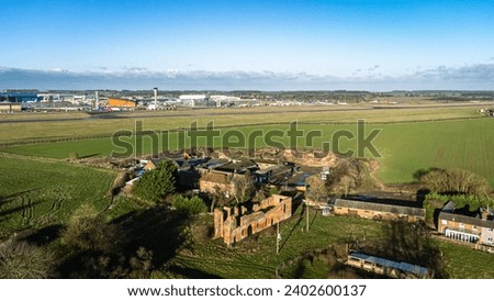 A beautiful view of a landscape with Someries Castle and Luton Airport