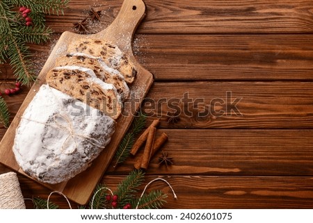 Composition with tasty Christmas stollen on wooden background