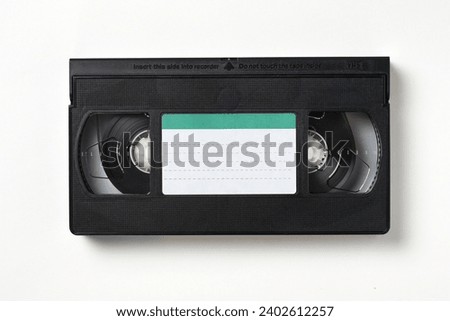 Video cassette tape isolated on white. Old analog tape VHS cassette, close-up. Retro and vintage Royalty-Free Stock Photo #2402612257