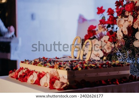 A closeup shot of a large square 60th birthday cake