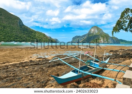 El Nido, Palawan Philippines - December 18, 2023: Boats and beach bars in El Nido beach.Palawan, people on white sandy beach in popular tourist destination of El Nido, Palawan.  Royalty-Free Stock Photo #2402633023