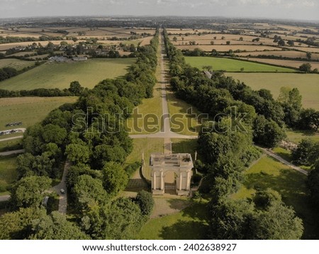 An aerial shot of the Stowe landscape gardens with Corinthian arch lined with trees in Buckinghamshire, England