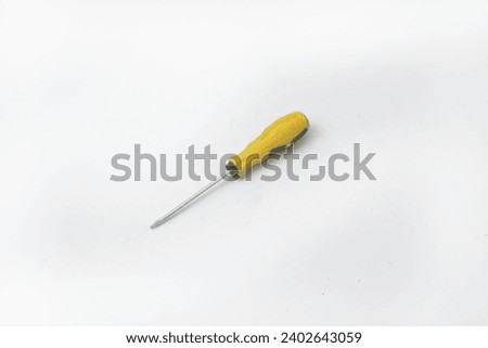 A yellow screwdriver often used by craftsmen is on an isolated white background