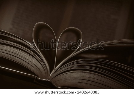 A heart-shaped book with its pages spread out in a fan pattern