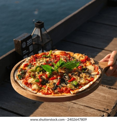 Top shot of a Margherita pizza on an ocean background. Close-up of Margarita Pizza with Tomatoes, Basil, and Mozzarella Cheese.