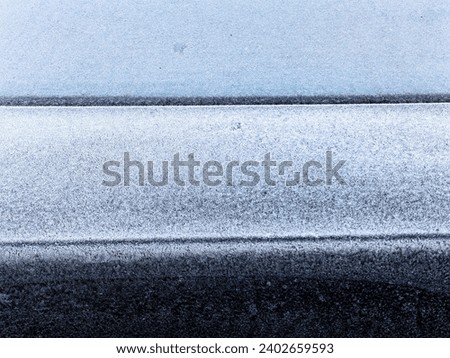 Frozen back  window . Background. Layers.  Trunk, part of the car. White , gray and black colors.