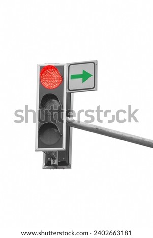 There is a traffic light on white background. The red light is on. It is close up view