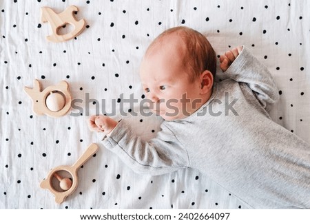 Portrait of 2 weeks old baby. Healthy physical and mental development of child. Newborn baby at first months of life. Royalty-Free Stock Photo #2402664097