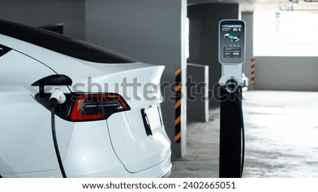 EV electric car recharge at shopping center parking lot charging in downtown city showing urban sustainability lifestyle by green clean rechargeable energy of electric vehicle innards Royalty-Free Stock Photo #2402665051