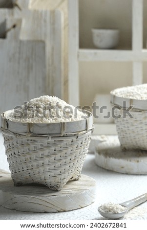 Organic rice in rattan basket with white background. Beras organik