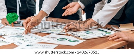 Eco business company meeting with group of business people planning strategy and discuss marketing of eco-friendly and renewable clean energy products. Green business company concept. Trailblazing Royalty-Free Stock Photo #2402678525