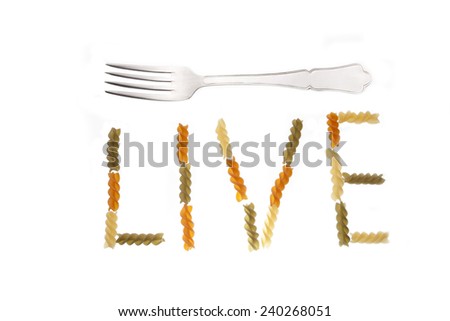 live written with pasta spirals and fork on white background