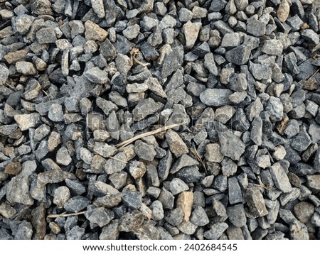 gravel stones on the road, asphalt road base material Royalty-Free Stock Photo #2402684545