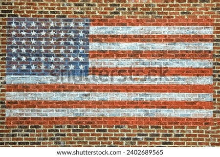 star and stripes american flag painted on brick wall