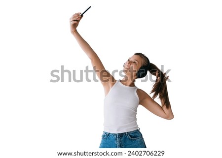 Fit healthy Caucasian young woman in white t-shirt and blue jeans uses headphones makes selfie against transparent background. Pretty hispanic girl makes video call