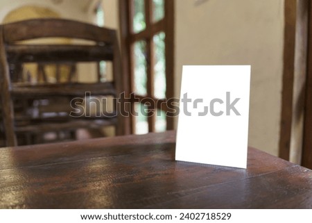 Menu mock up blank for text marketing promotion. Mock up Menu frame standing on wood table in restaurant space for text.