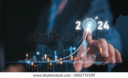 2024 business target goal finance technology and investment stock market trading concept. businessman holding virtual graph icon analysing forex or crypto currency trading graph financial data.