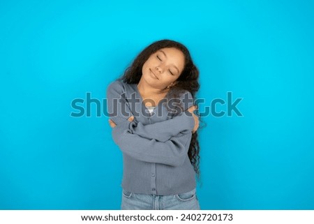 Young beautiful teen girl Hugging oneself happy and positive, smiling confident. Self love and self care
