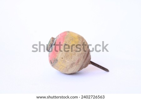 
A spinning top, or simply a top, is a toy with a squat body and a sharp point at the bottom, designed to be spun on its vertical axis, Royalty-Free Stock Photo #2402726563