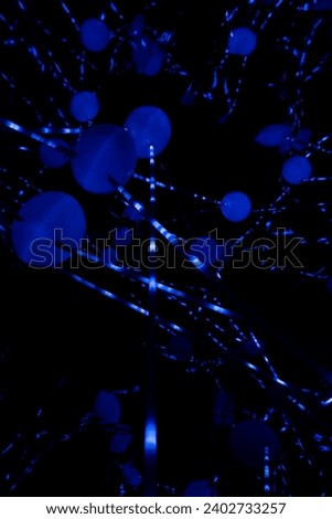 Glowing blue abstract circular round spherical lights in darkness with black background. Physics, chemistry, future technology, abstract art concept.