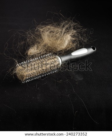 Alopecia concept hairbrush full of lost hair