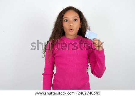 Photo of Young beautiful teen girl amazed shocked hold credit card payment