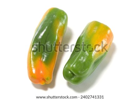 Two discolored substandard green peppers white background Royalty-Free Stock Photo #2402741331