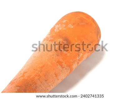 Damaged substandard carrot white background closeup Royalty-Free Stock Photo #2402741335