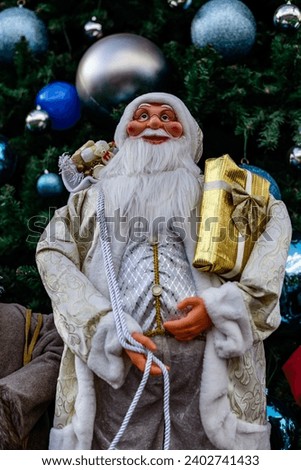 Santa in group or standing alone in front of beautiful christmas tree decorative with chritmas toys, balls and gifts box.