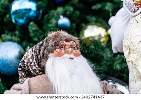 Santa in group or standing alone in front of beautiful christmas tree decorative with chritmas toys, balls and gifts box.
