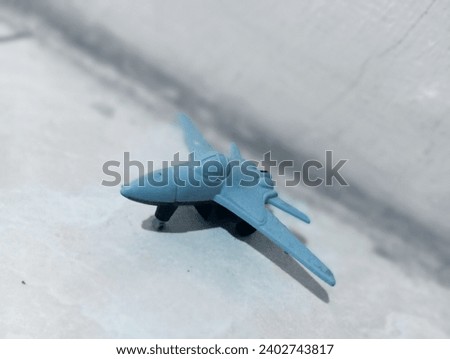 Gray toy airplane with blurred black background