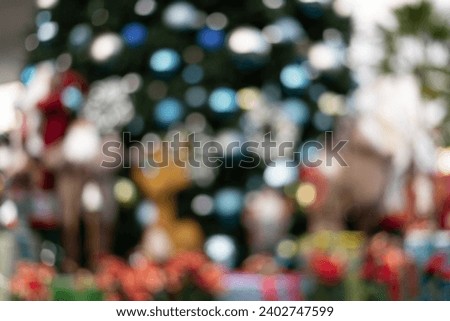 Defocus and blur image of Santa in group in front of beautiful christmas tree decorative with chritmas toys, balls and gifts box.