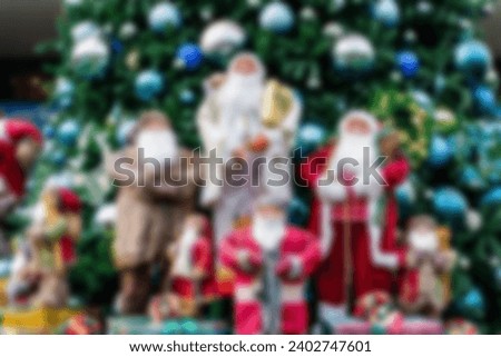 Defocus and blur image of Santa in group in front of beautiful christmas tree decorative with chritmas toys, balls and gifts box.