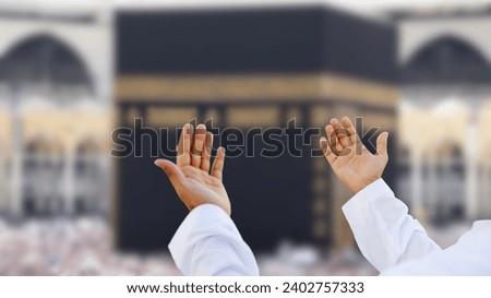 Muslim praying to Allah in front of Kaaba. Islam Iconic Mosque, Al Haram Mecca Saudi Arabia. Muslim Praying Hands in front of The Holy Kaaba which is the center of Islam inside Masjid Al Haram Mecca. Royalty-Free Stock Photo #2402757333