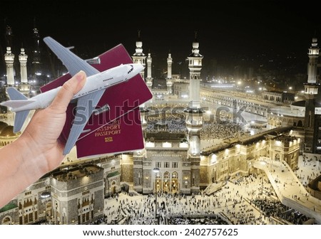 Plane travel concept, hand holding passports with plane, Macka, Makka, Haj, cityscape in background