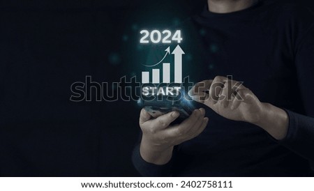 Businessman touching to choose year 2024 for starting preparing Merry Christmas and Happy New Year. Business planning concepts. Start up