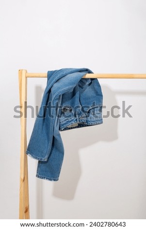 Blue jeans denim pants on a wooden rack