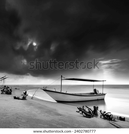 wooden boat near the beach during storm, located at fisherman village Terengganu, long exposure shot. black and white photography.