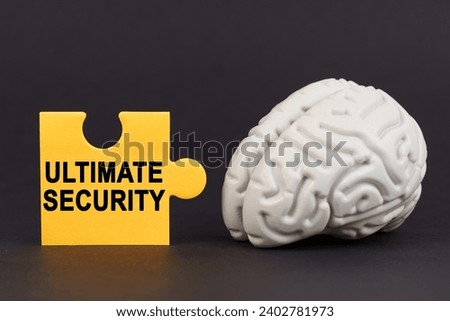 On a black surface there is a brain and a yellow puzzle with the inscription - Ultimate security. Business and technology concept.