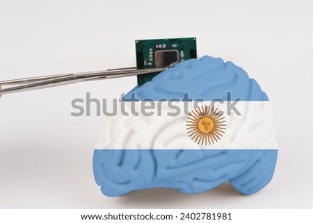 On a white background, a model of the brain with a picture of a flag - Argentina, a microcircuit, a processor, is implanted into it. Close-up