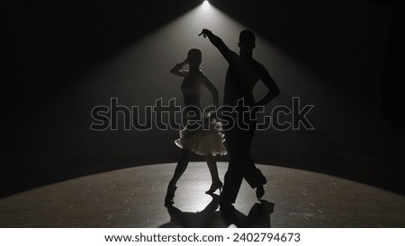 Silhouette Elegant Ballroom Dance Couple on Spotlight. Royalty-Free Stock Photo #2402794673