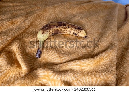 bananas in dark spots on fabric with shadows