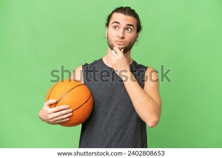 Young basketball player man over isolated background having doubts and thinking