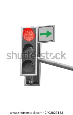 There is a traffic light on a white background. The red light is on. It is close up view