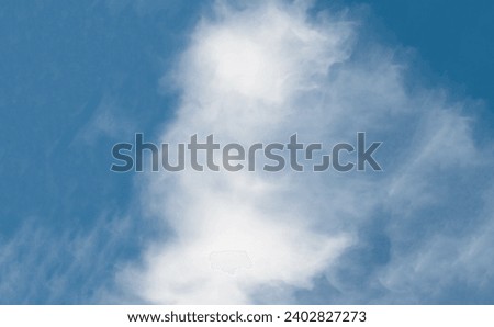 It is the blue sky background. This is a blurred view of big white Spindrift cloud in blur blue sky. It is a fairy cloud in sky. It is a sunny day.