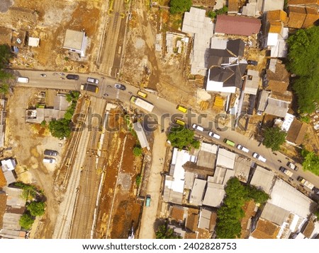Industrial Photography Landscapes. Aerial view of the intersection of railway tracks and public roads, Located in Cicalengka, Bandung - Indonesia. Aerial Shot from a flying drone.